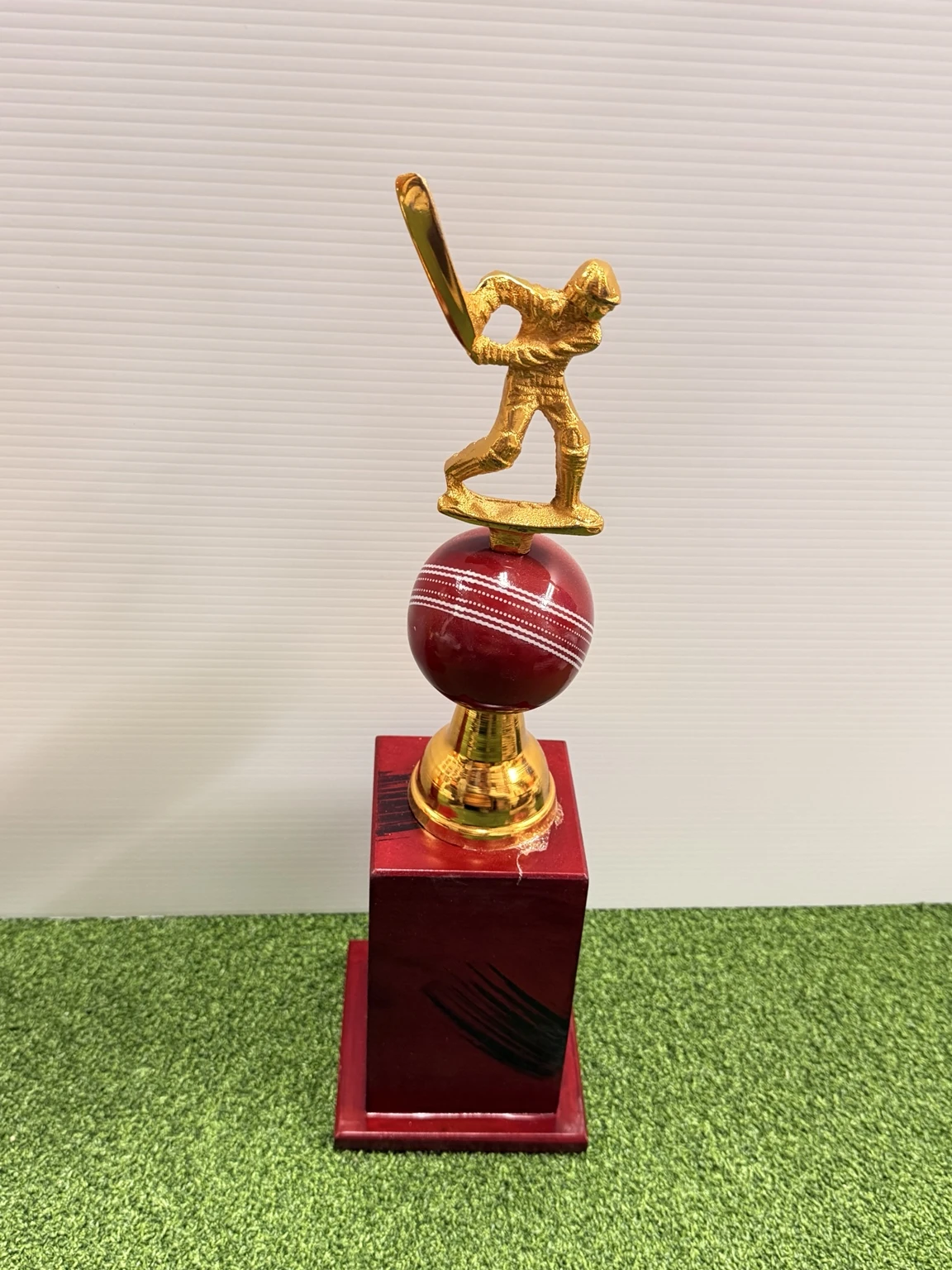 16-inch cricket trophy featuring a golden batsman on a red seam cricket ball with a wooden base - Albert Cricket Store