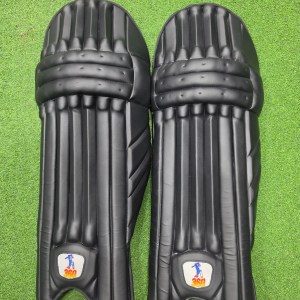 Top face view of EM 360 PLAY BURST adult white cricket batting pads on green artificial turf on Alberta.