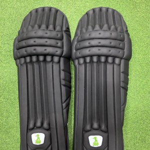 Inner back padded view of EM 360 Bull Ring adult black cricket batting pads with green trim on Alberta.