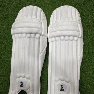 Top view of EM 360 No 17 adult white cricket batting pads on green artificial grass on Alberta.